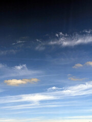 Fluffy White Clouds in a Blue Sky as A Skyscape Background