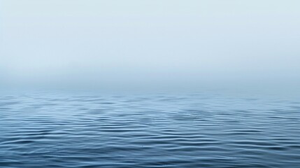 Obraz premium Calm Blue Ocean Surface with Gentle Ripples Under Misty Sky. Generative AI