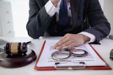 Handcuffs and legal documents were placed on table inside lawyer office after court decision was...