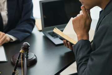 client meets with a lawyer within the legal counsel office to request advice about law and lawsuit...