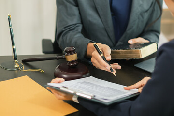 client meets with a lawyer within the legal counsel office to request advice about law and lawsuit...