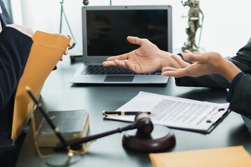 client meets with a lawyer within the legal counsel office to request advice about law and lawsuit...