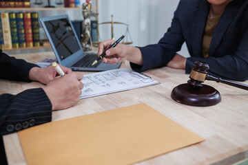 client meets with a lawyer within the legal counsel office to request advice about law and lawsuit...