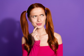 Photo portrait of attractive young woman look skeptical empty space dressed stylish pink clothes isolated on violet color background