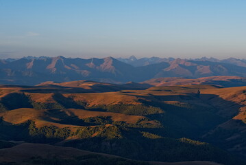 Russia, the Elbrus region. Stunning dawn view of the Caucasus mountains from the cliffs of the Bolshoy Bermamyt plateau.