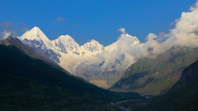timelapse of panchachuli peaks of himalaya in morning. The sunlight coming on the valley on the foothills of the mountain. The video taken from Dantu village of darma valley uttarakhand. 