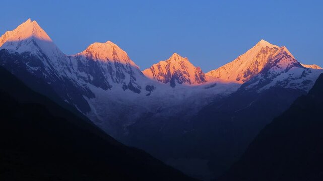 timelapse of sunrise over panchachuli peaks of himalaya. The golden sunlight on the snow peaks of the mountains. The video taken from Dantu village of darma valley uttarakhand. 
