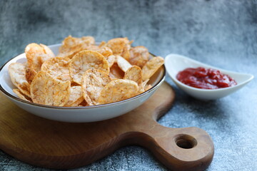 Brown rice chips with spices and salt in bowl