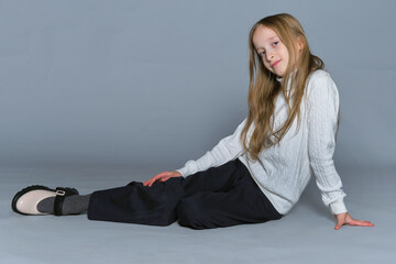 Young model with a contented smile, comfortable in her winter attire, captures the essence of...