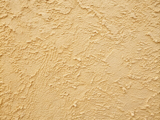 Softly focused stucco wall in warm cream hue with subtle texture, evoking Mediterranean charm, perfect for architectural visuals or adding cozy backdrops to designs.