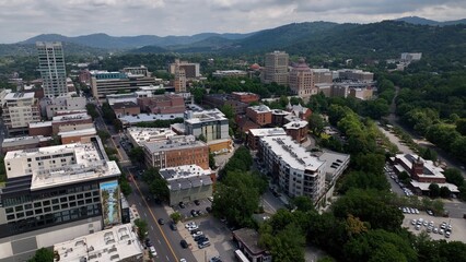 City skyline of Asheville, NC at the base of the Blue Ridge Mountains in North Carolina, a living and vacation destination in the Southern, United States showing architecture of buildings and streets