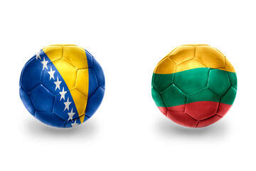 football balls with national flags of lithuania and bosnia and herzegovina,soccer teams. on the...
