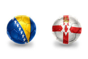 Obraz premium football balls with national flags of northern ireland and bosnia and herzegovina,soccer teams. on the white background.
