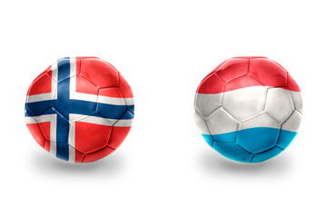 Obraz premium football balls with national flags of luxembourg and norway ,soccer teams. on the white background.