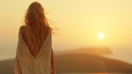 Fototapeta premium Young woman with long blonde hair stands on a hill, gazing at the sunset, feeling peaceful and inspired by nature's beauty during summer evenings