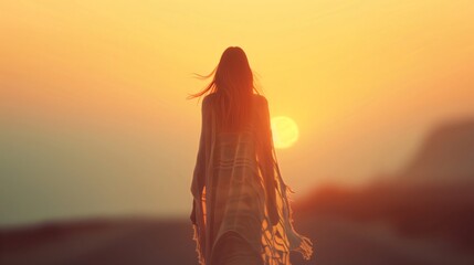 Woman walks towards the sunset, embracing nature's tranquility and beauty, finding inspiration in the evening sky