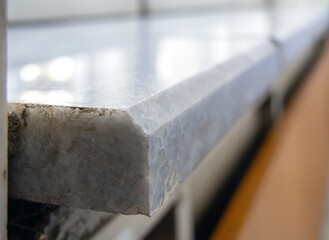 Fragment of a polished marble window sill. (Shallow depth of field)