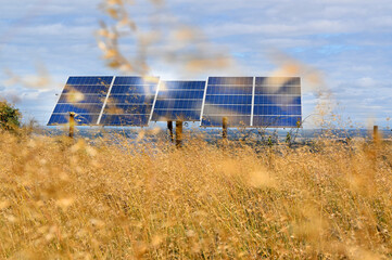 Solar panels photovoltaic park with sun reflection, on a field in Spain, Europe. Solar collector...