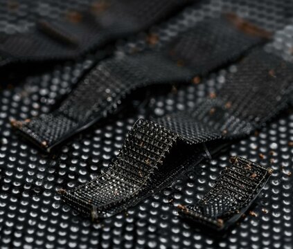 Close-up of a piece of black hook and loop material. AI.
