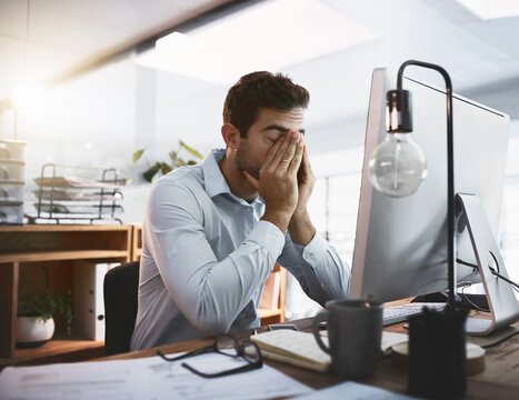 Crisis, stress and tired businessman in office on computer working for deadline, pressure or online report. Corporate demand, eye strain and exhausted database administrator with fatigue or burnout