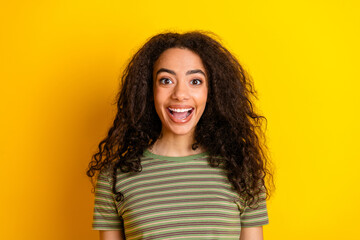 Fototapeta premium Photo of impressed lovely girl with wavy hairstyle dressed striped t-shirt astonished staring isolated on yellow color background