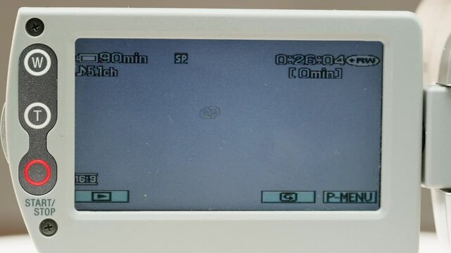Old vintage video camera close-up. Popular retro camcorder shooting. Non disk on video-camera monitor.
