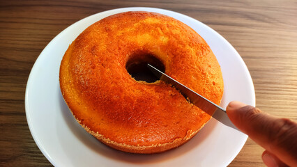 Traditional brazilian cornmeal cake being sliced
