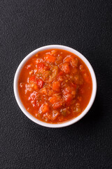 Red hot or spicy sauce with chili peppers, tomatoes, garlic, spices
