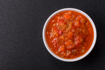 Red hot or spicy sauce with chili peppers, tomatoes, garlic, spices