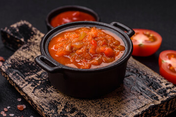 Red hot or spicy sauce with chili peppers, tomatoes, garlic, spices