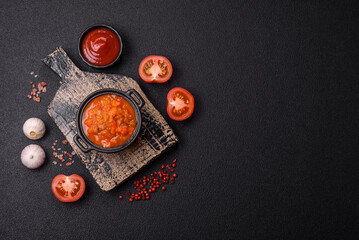 Red hot or spicy sauce with chili peppers, tomatoes, garlic, spices