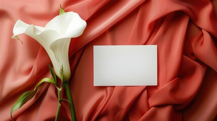 Elegant table arrangement with white card and calla lily on colorful backdrop