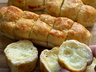 Fresh bread baked on the table. Creamy garlic bread with cheese.