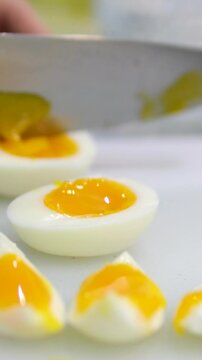 Cutting a soft-boiled egg in close up
