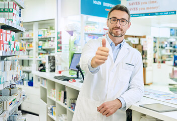 Happy man, portrait and pharmacist with thumbs up for healthcare, pharmaceutical or medical supplies at pharmacy. Mature male person with like emoji, yes sign or ok for good review, vote or thank you