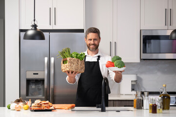 Hispanic man preparing food in kitchen. Chef man cooking healthy food at home. Man in kitchen. Healthy diet, vegetarian. Healthy food for dinner. Steam vegetables