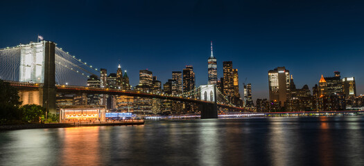 Panoramic view of Brooklyn Bridge and New York skyline at night long exposure
