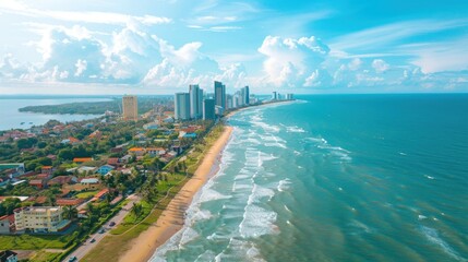 Naklejka premium A beautiful beach with a city in the background. The ocean is calm and the sky is clear