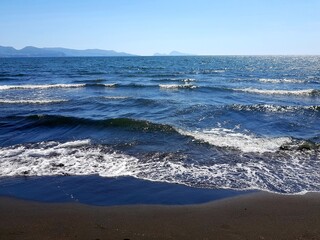 Blue sea waves run over the sandy