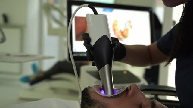 Dental scanner applying in stomatology clinic 4k video. Assessment of patient teeth condition with dental hardware.