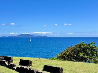 seaside of Guadeloupe in the French West Indies with ruins on a lawn and view of the Saintes...