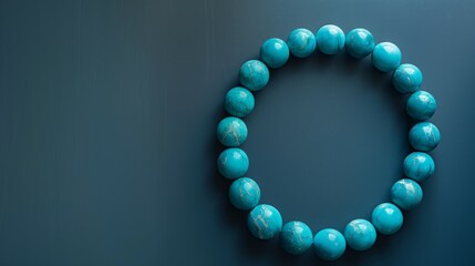 Obraz premium Turquoise Bead Bracelet on Smooth Surface with Subtle Lighting