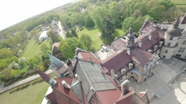 This captivating aerial footage takes you on a mesmerizing journey above the magnificent Ksi Castle, Poland. Nestled amidst lush greenery and tranquil waters, the castles grandeur is truly