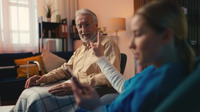 Nurse ignoring her elderly patient in a nursing home, unprofessional behavior