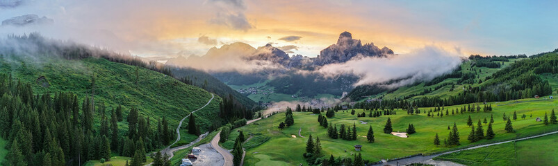 Spectacular panorama with sunset over golf course Corvara