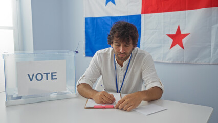 Young man taking notes in an electoral room with a panama flag and a ballot box indicating a voting process indoors