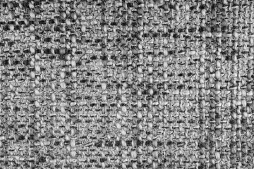 Texture of gray jacquard fabric of rough weave, melange or mixed color cloth structure macro