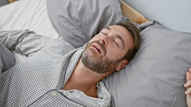 Handsome middle-aged hispanic man sleeping peacefully in a comfortable bedroom setting - Powered by Adobe