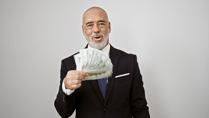 A mature man in a business suit showing us dollars against a white isolated background.