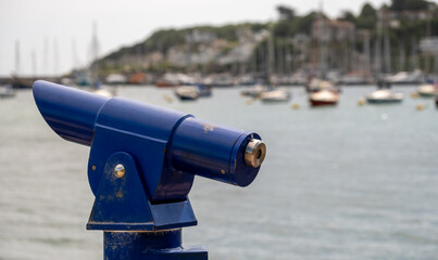 Close and selective focus on a viewing telescope in Brixham Harbour